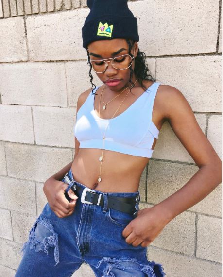 Paige Chestnut posing in tops and jeans